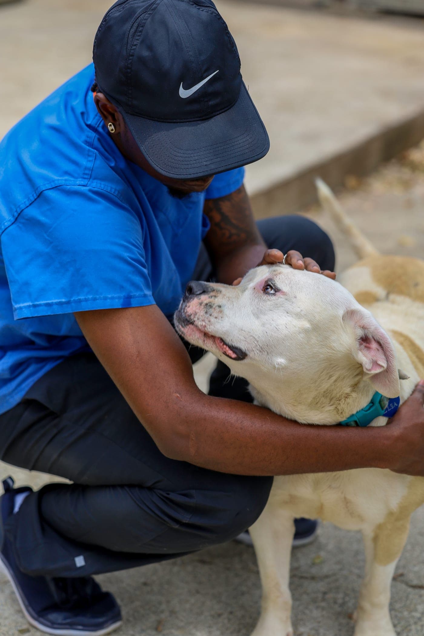 An HSSTT caregiver hugging a rescued dog