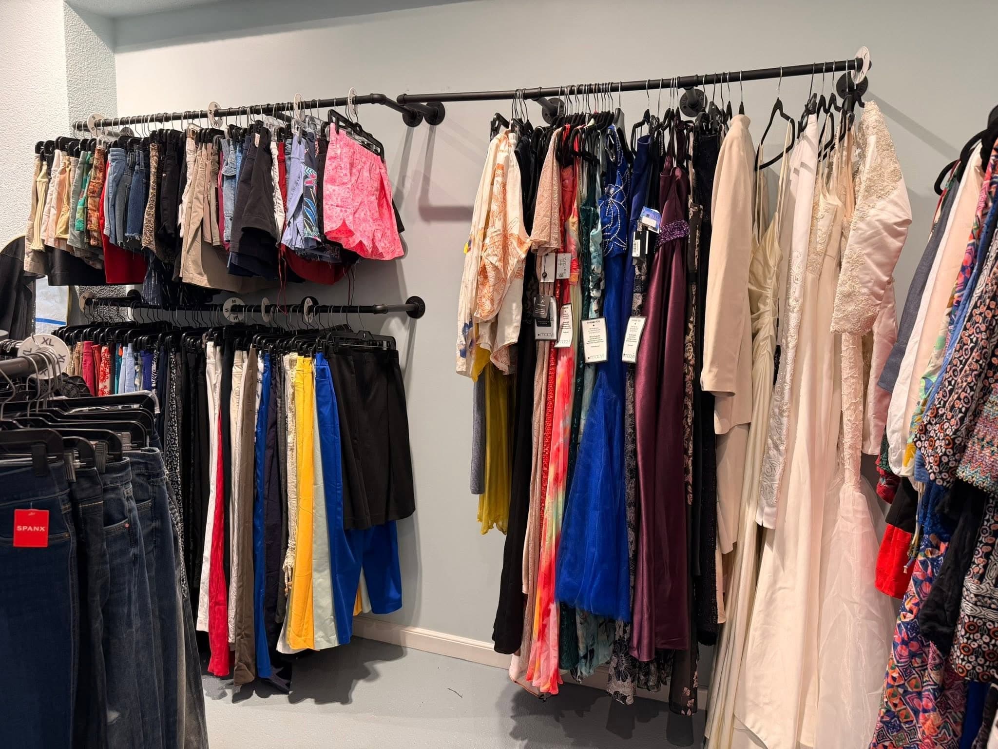 The HSSTT Thrift Store interior — organized racks of clothing and finds